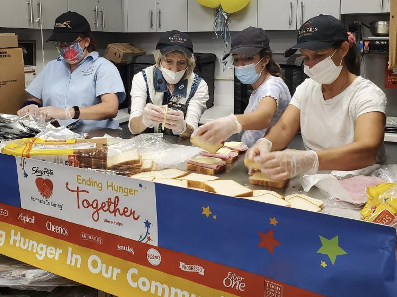 Volunteers making sandwiches for the Homeless